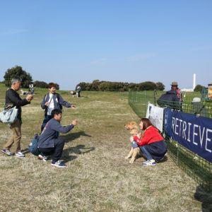 横断幕前で記念撮影する一家